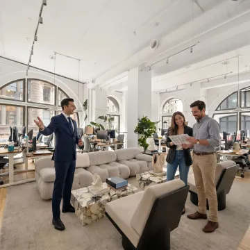 Commercial real estate advisors touring office space with startup clients