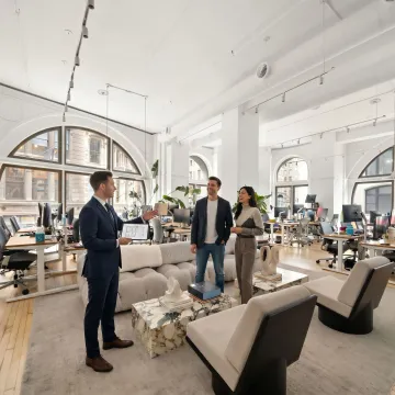 Startup team touring office space with broker
