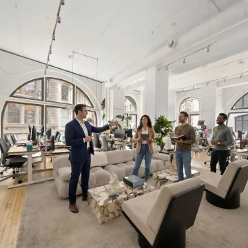 Broker guiding a startup team through office tours