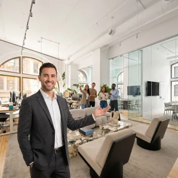 Startup team touring a modern office with a broker