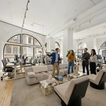 Commercial real estate team touring a modern NYC office