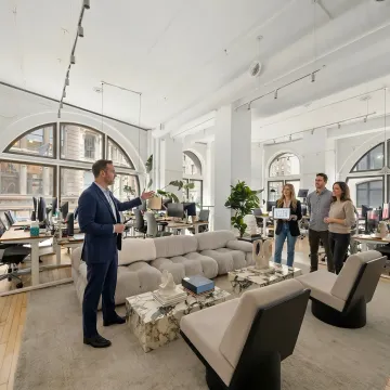Startup team touring office space with real estate advisor