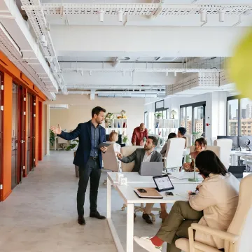 Commercial real estate advisor touring office space with a startup team