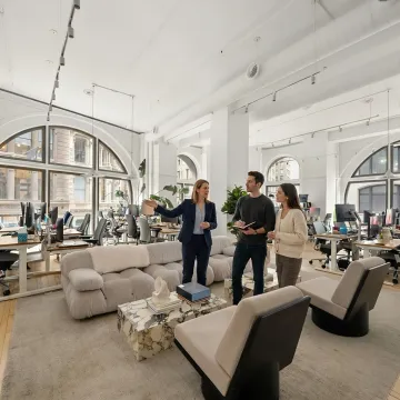 Broker guiding clients through an NYC office tour
