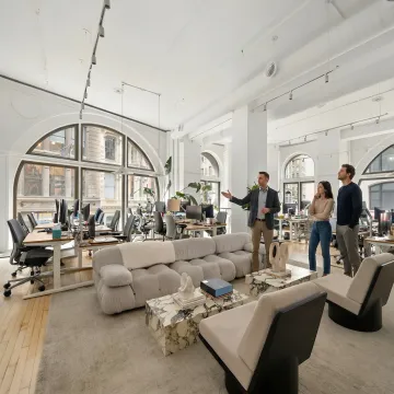 Commercial office broker touring a modern workspace with clients