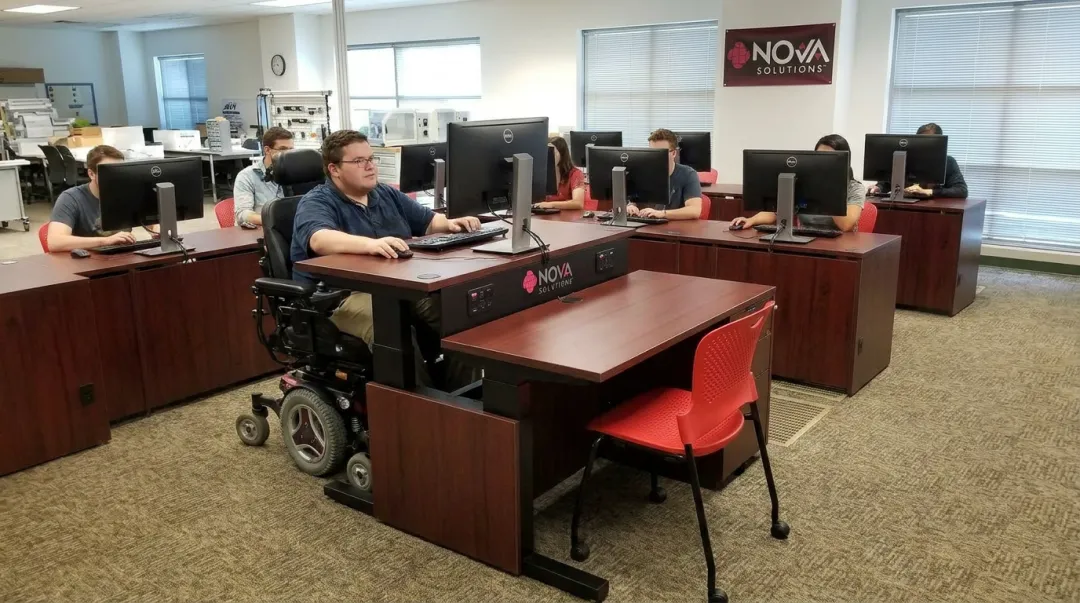 NOVA Solutions height-adjustable ADA-compliant computer training desk in classroom setting