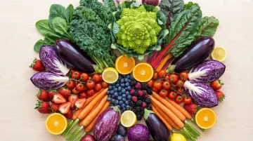 Colorful array of antioxidant vegetables and berries including broccoli kale and blueberries