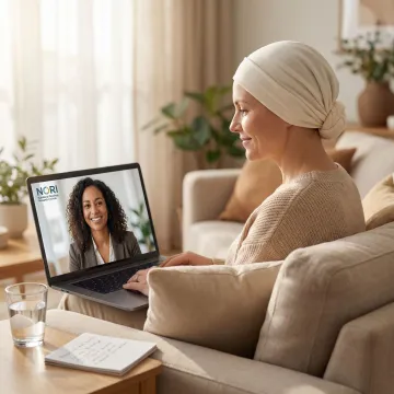 A compassionate nutritional oncology consultant speaking with a breast cancer patient via video call