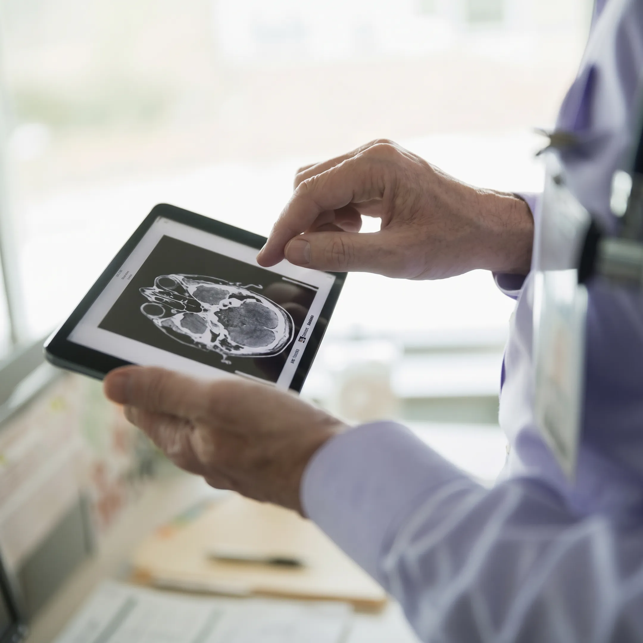 Attorney reviewing traumatic brain injury claim documents with a client