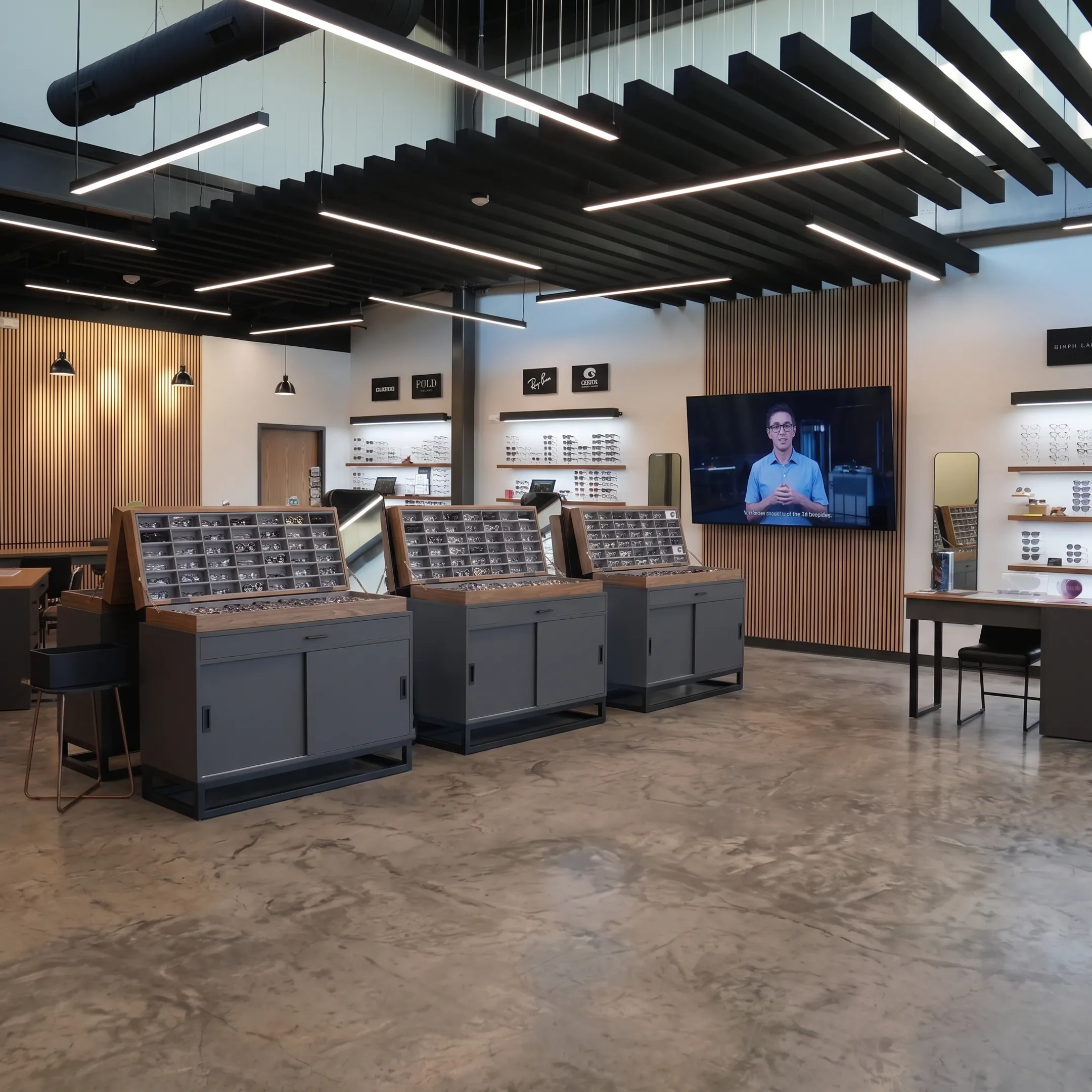 Custom optical retail interior featuring eyewear displays, signage, and digital screens