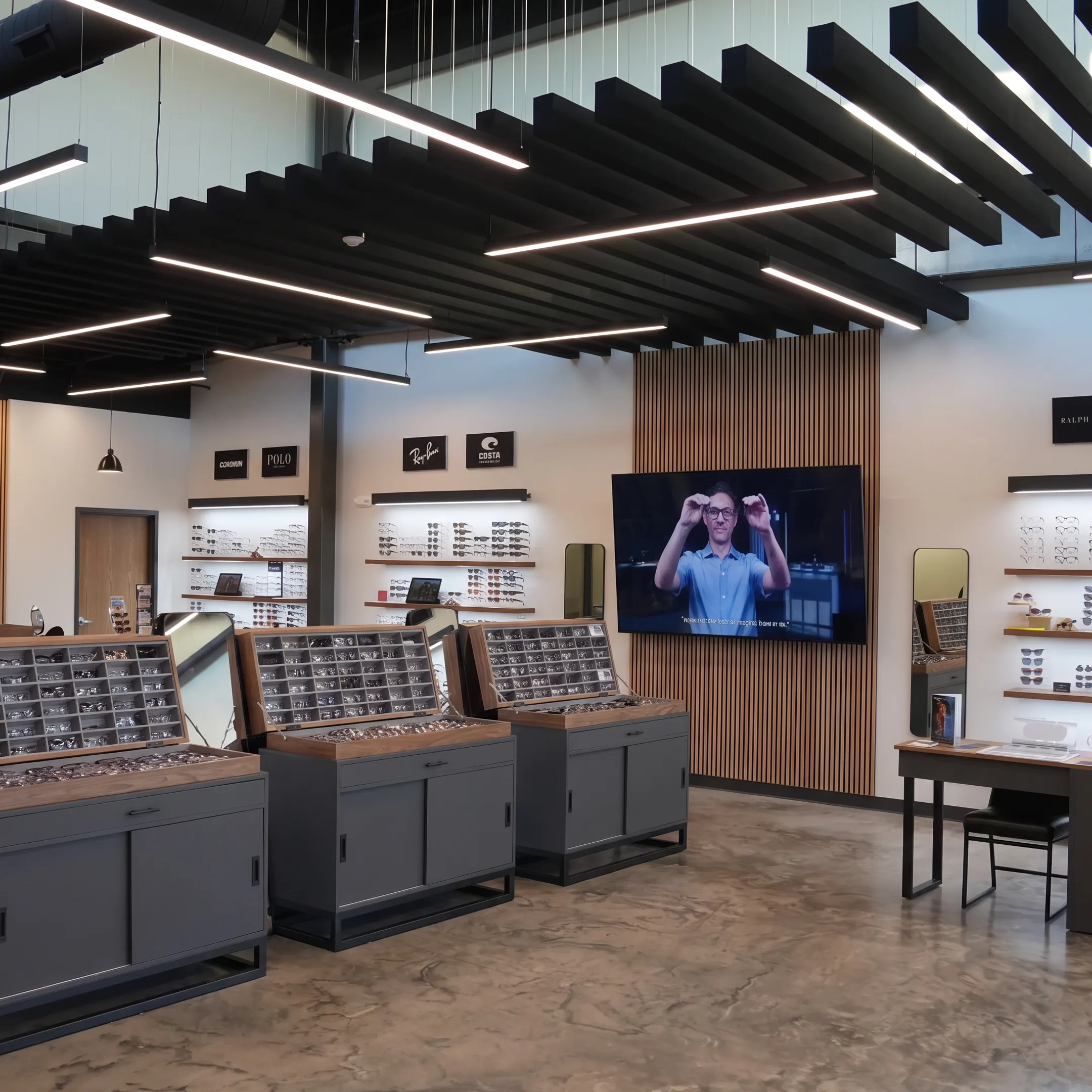 Interactive digital eyewear display beside curated optical merchandise