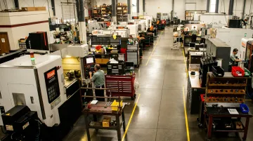 Manufacturing production floor with active machinery showing throughput and equipment utilization