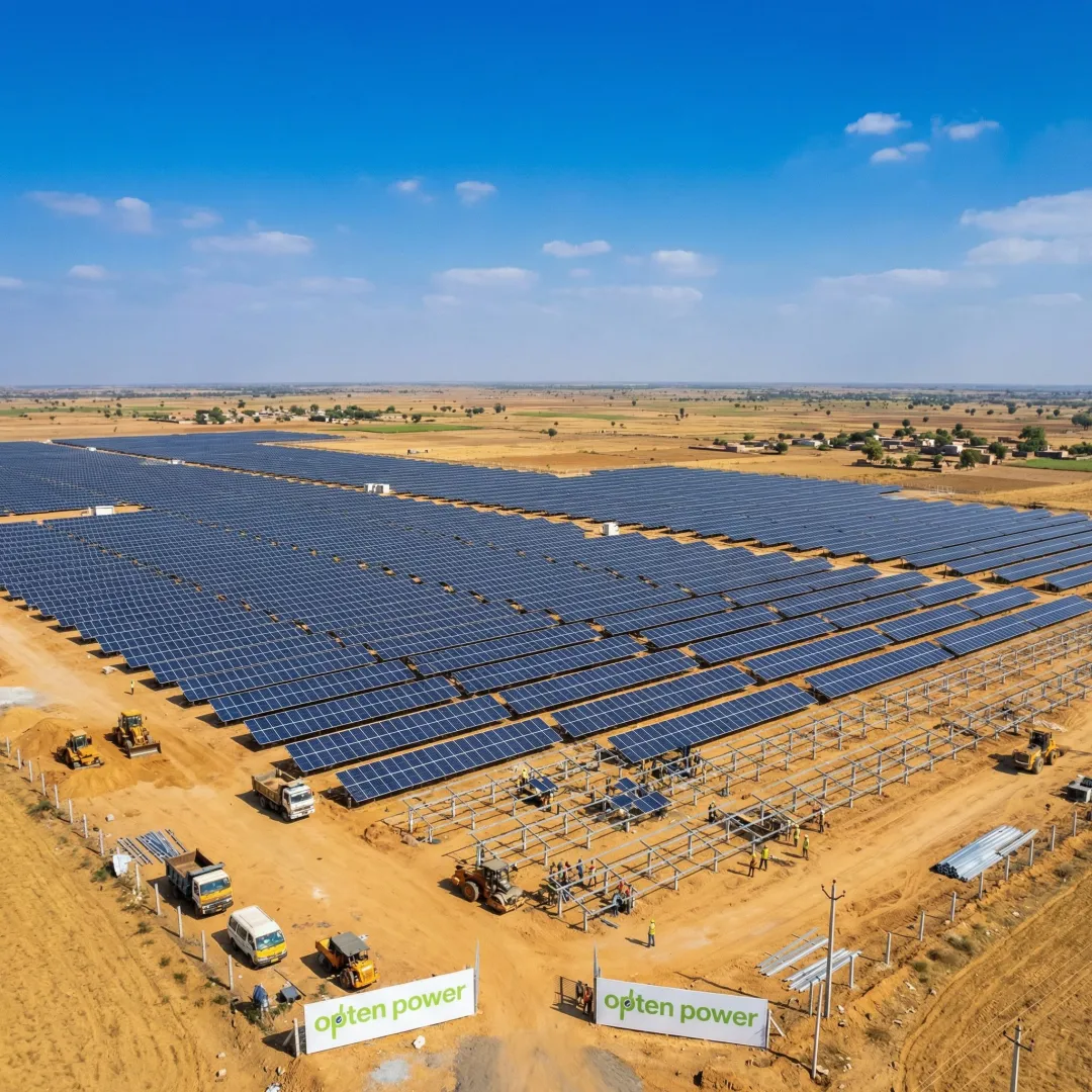Large-scale greenfield solar farm under development in India with rows of solar panels and clear skies
