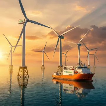 Offshore wind turbines operating in open ocean waters at sunrise