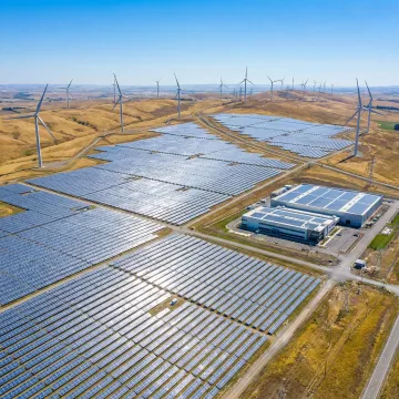 Industrial renewable energy solutions with solar panels and wind turbines at a large manufacturing facility