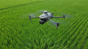 Agricultural drone with multispectral optical sensor scanning crop field canopy