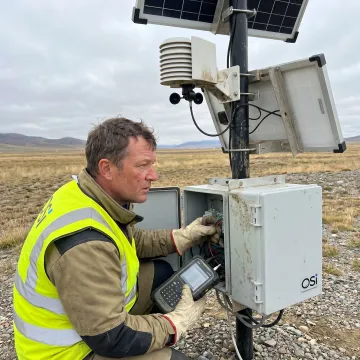 Engineer commissioning environmental monitoring station sensors
