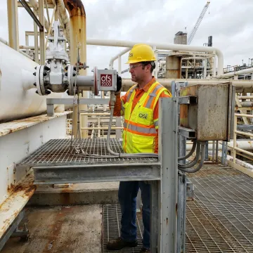 Engineer checking exhaust gas flow monitoring equipment