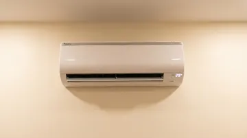 Daikin inverter split AC indoor unit with triple LED display showing power and temperature readings