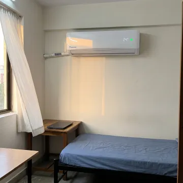 Hostel room with split AC unit