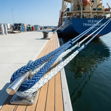 Heavy-duty mooring lines securing a commercial vessel at a marina dock