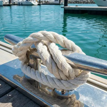 Close-up of marine-grade mooring rope secured to dock cleat