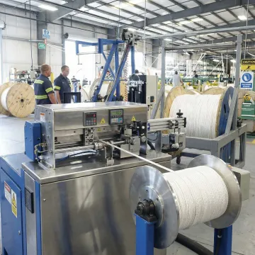 Professional rope spooling equipment preparing custom-cut industrial cordage
