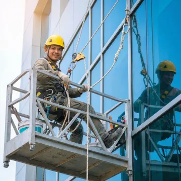 Safety contractor using fall protection rope on construction site