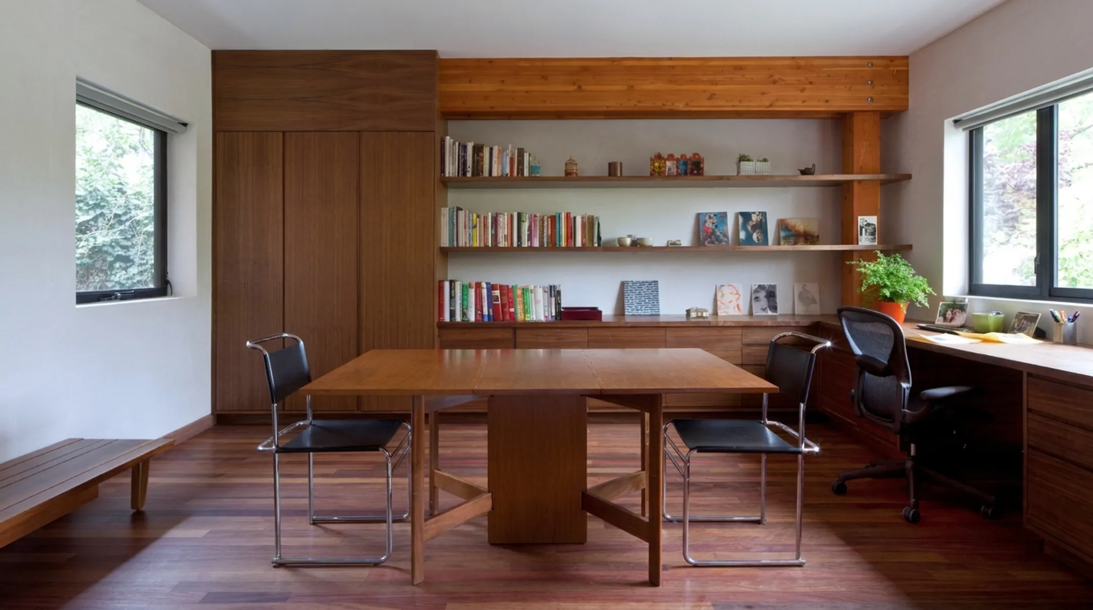 Built-in office desk flanked by tall storage cabinet towers