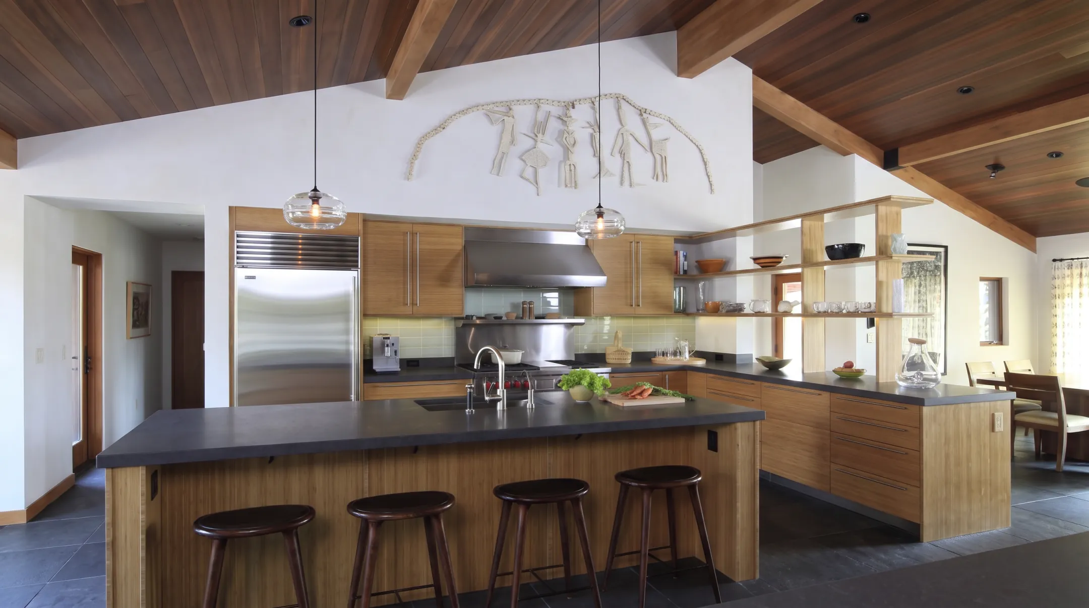Log cabin kitchen with walnut cabinetry island and ventilation system