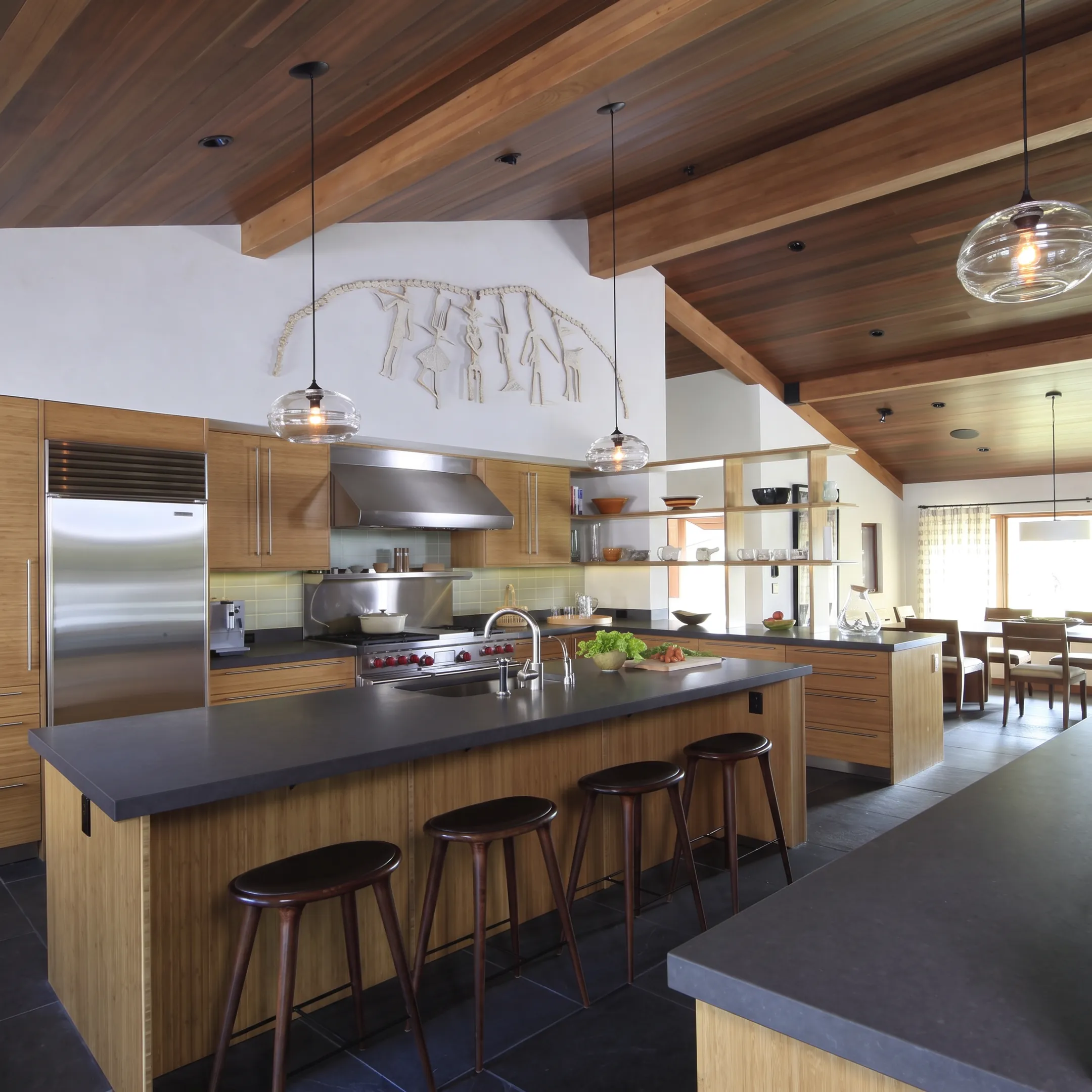 Designer reviewing a custom kitchen plan with homeowners