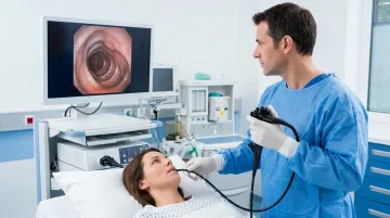 Pulmonologist performing flexible bronchoscopy procedure in clinical bronchoscopy suite