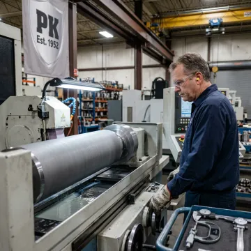 Technician restoring an industrial metal component