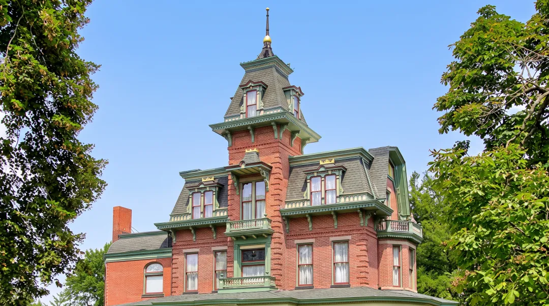 Two-story colonial home with complex roofline featuring multiple gables dormers and steep roof pitch
