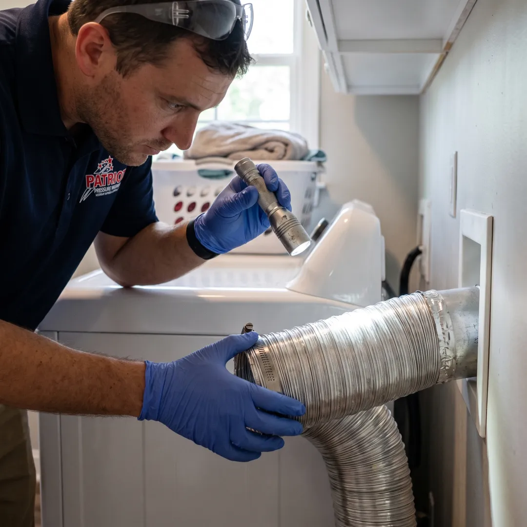 Clean dryer vent connection behind laundry machine