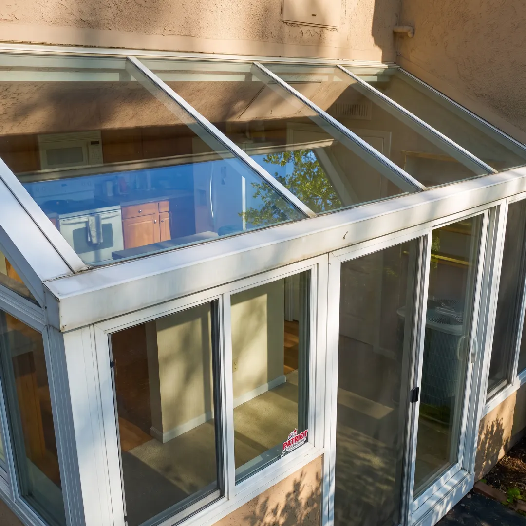 Freshly cleaned residential windows reflecting daylight