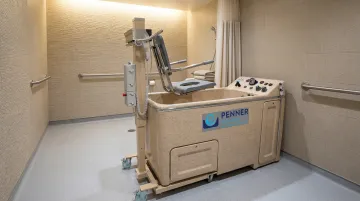 Penner motorized bathing system with height-adjustable transfer components for long-term care residents