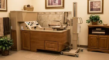 Penner Bathing long-term care bathing system with height-adjustable transfer post and home-like finish