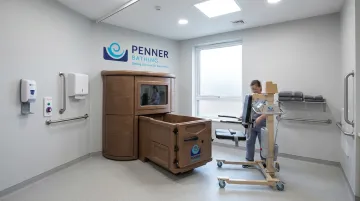 Long-term care bathing system with height-adjustable transfer and bariatric capacity features