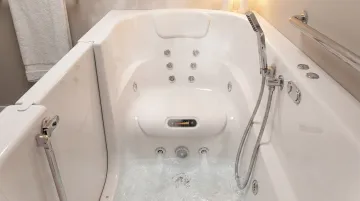 Walk-in bath interior showing jet system heated seat and handheld shower wand