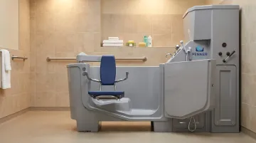 Penner Bathing healthcare bathing system showing transfer chair and height-adjustable design