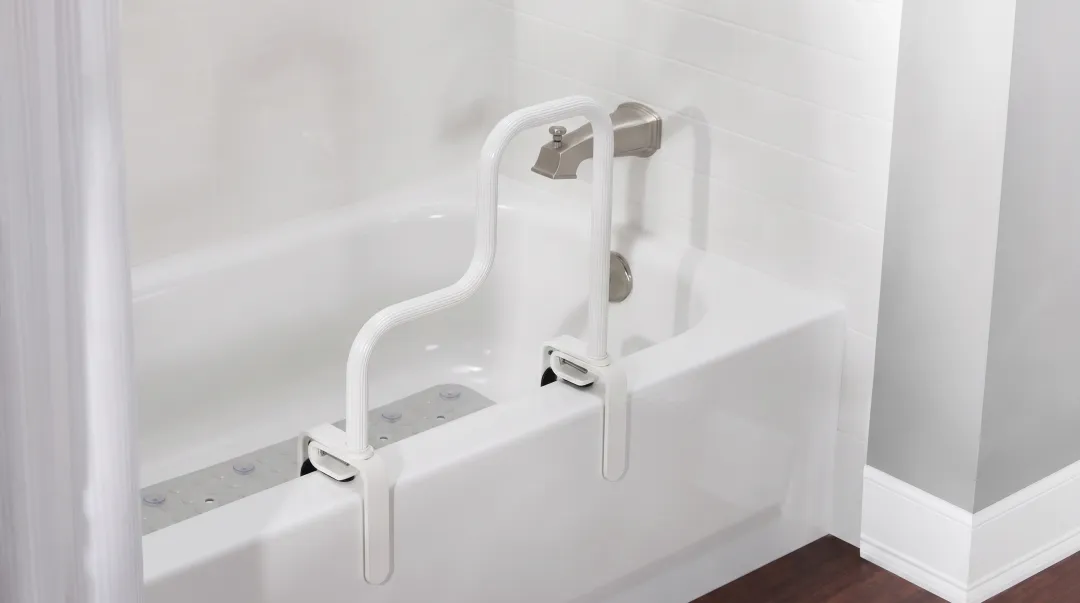Bathroom grab bar and non-slip mat installed near standard bathtub