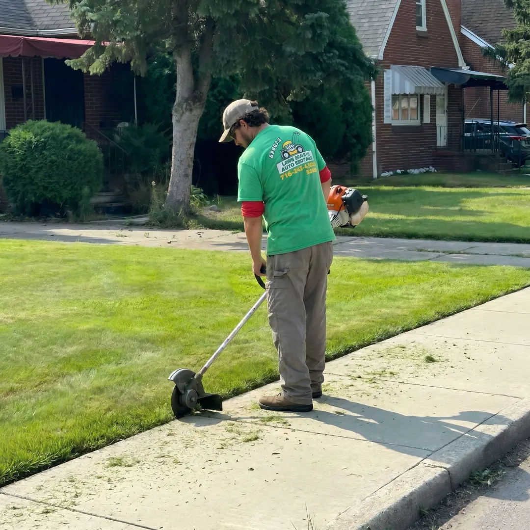 Lawn care professional edging a walkway
