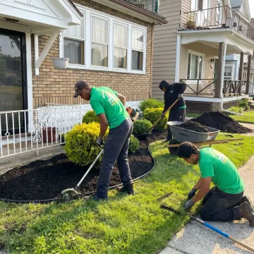 Crew restoring lawn and landscape beds