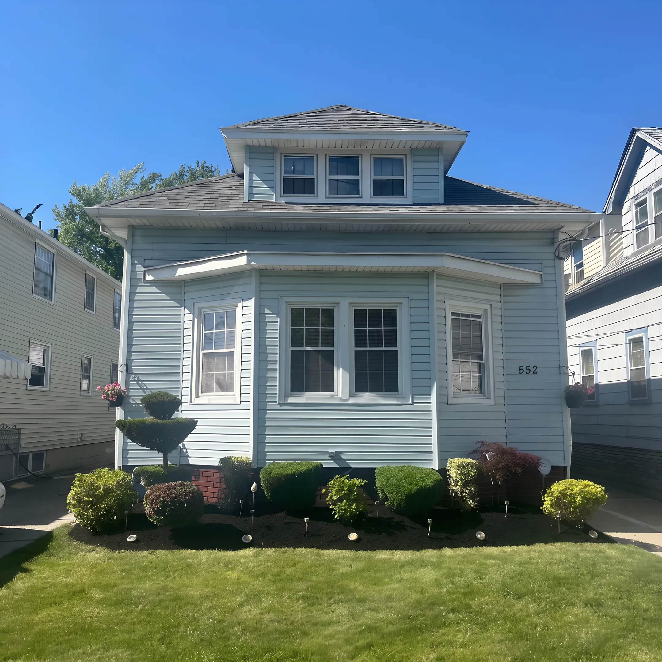 Freshly landscaped yard with planting beds and mulch
