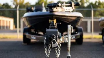 Boat trailer with security lock and padlock at outdoor storage facility