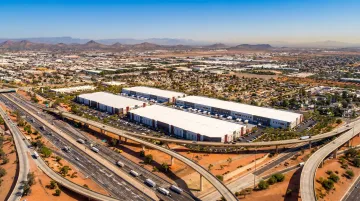 Sun Belt industrial warehouse district aerial view with distribution centers and highway access
