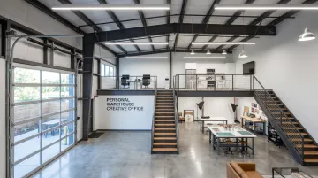 Personal Warehouse creative office unit interior showing mezzanine LED lighting and workspace layout