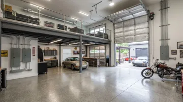 Personal Warehouse garage condo interior with mezzanine oversized doors and three-phase electric