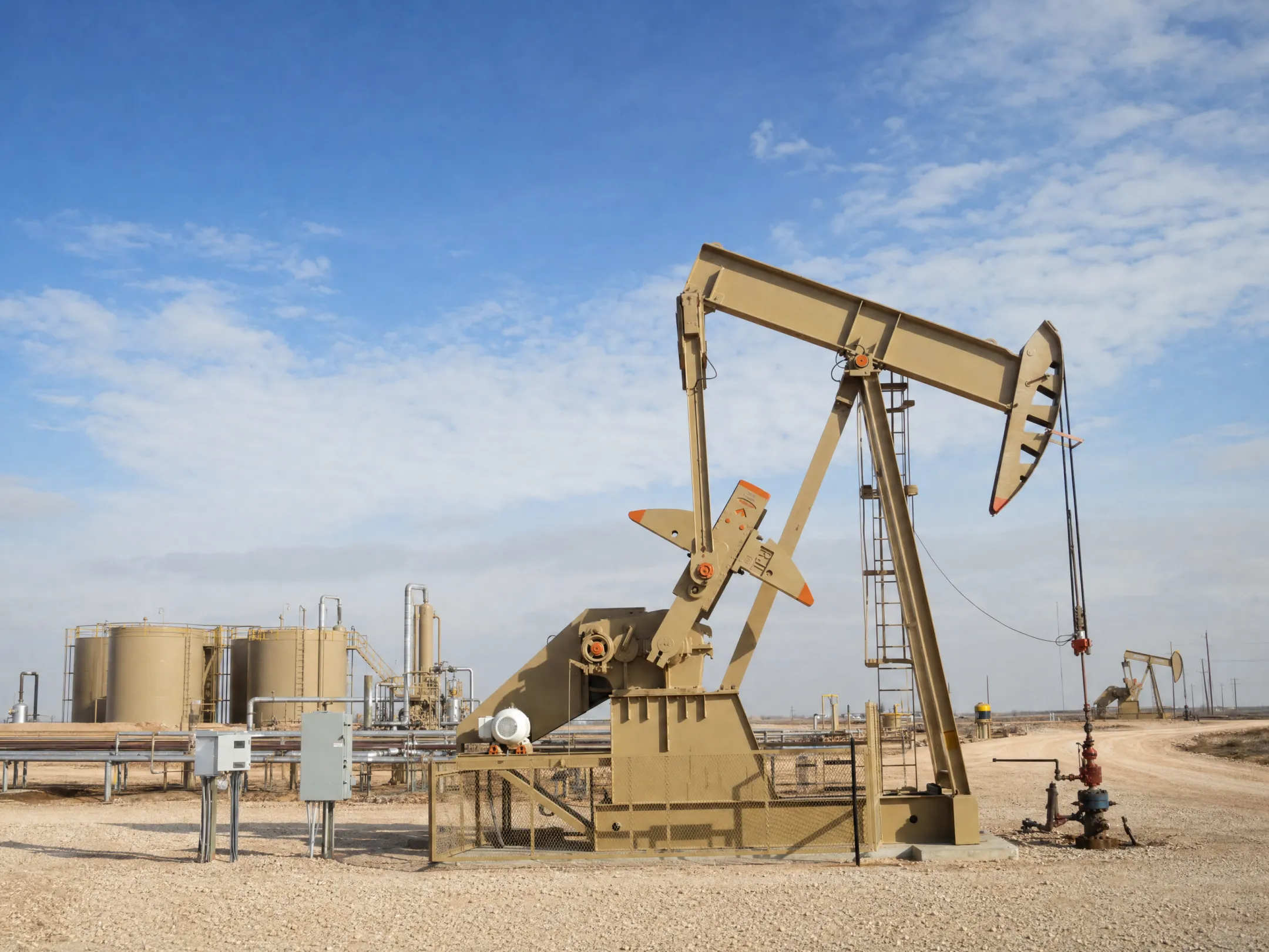 Natural gas drilling site with active wells and production equipment in Texas